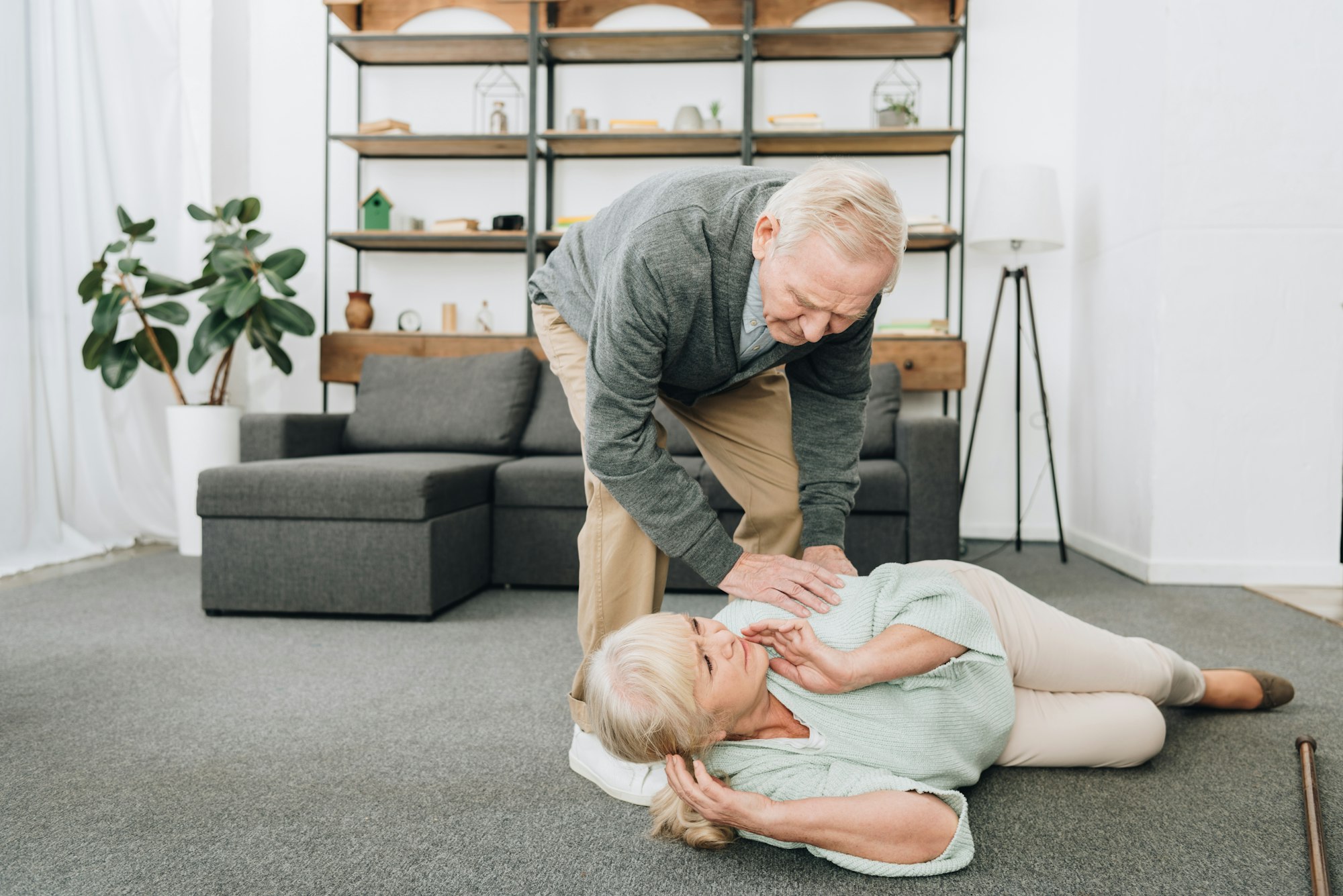 senior men helping at old woman who falled down on floor